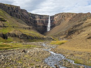 Waterfall Hengifoss, basaltic layers interwoven with red sedimentary layers, Iceland, Europe