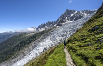 Hiking on the trail to La Jonction, Glacier des Bossons, behind the summit of the Aiguille du Midi,