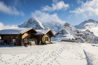 Wooden chalet and ski slope, with views of the Eiger, Mönch and Tschuggen, Grindelwald, Bernese