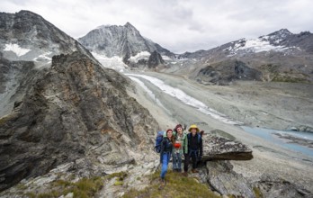 Group of mountaineers at Col de Riedmatten, view of glacier Glacier de Cheilon and mountain peak
