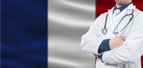France Health and Care concept. Male doctor on France flag. Doctor with crossed arms on France flag