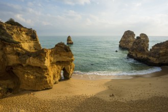 Rocky coast with beach and red rocks, Praia do Camilo, Lagos, Algarve, Portugal, Europe