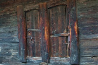 Closed wooden window shutter. Historic village of Mühlebach, Valais, Switzerland, Europe