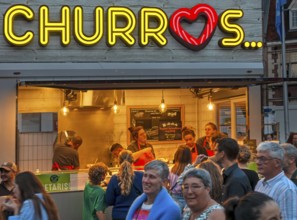 Churros stall selling fried choux pastry dough during the Gentse Feesten, Ghent city festival,