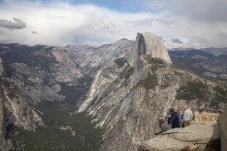 Yosemite National Park, California - Tourists viewing Half Dome in Yosemite National Park from