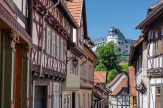 Street with half-timbered houses in the old town, the castle in the background, Stolberg im Harz,