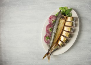 Smoked mackerel, top view, with spices, on a wooden table, no people, selective focus