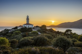 Lighthouse at sunset, surrounded by green hills and sea, Lastovo, Neretva, Croatia, Europe