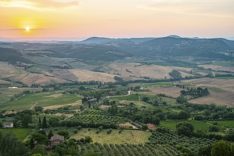 View from Montepulciano into a typical Tuscan landscape in Val d'Orcia with hills, trees, fields,