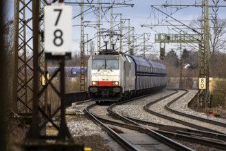 Goods train travelling on the winding Schuster Railway, overhead lines and infrastructure.