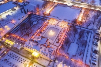 Aerial view of Wackerbarth Castle with castle park in snow and Christmas lights, Radebeul, Saxony,