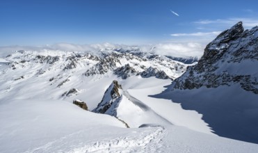 Mountain ridge of Piz Kesch, ascent on Piz Kesch or Piz d'Es-cha in winter, spectacular mountain