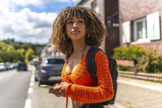 Side view of a beauty young latin woman using the gps of the phone to get directions in the city