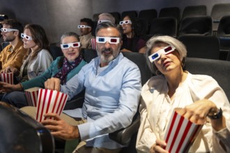People of different ages and ethnicities wearing 3d glasses and eating popcorn while watching a