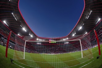 Overview, interior, floodlit match, behind-the-goal perspective, goal net, blue hour, fisheye shot,