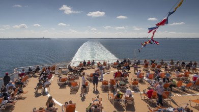 Passengers relax on deck in sunny weather, sun deck, car ferry Color Fantasy from Kiel to Oslo