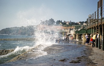 Waves of the rough sea hit the promenade near the railway station, Dawlish, Devon, England, United