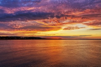 Colourful sunset with dramatic sky over calm sea, Rügen