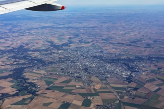View from an aeroplane over fields and a cityscape, flight, aerial view