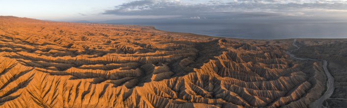 Landscape of eroded hills at Lake Issyk Kul, Badlands at sunrise, aerial view, Canyon of the
