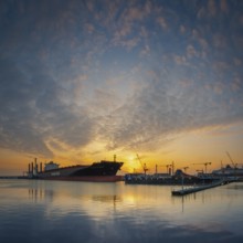 View of a harbour basin and a freighter at sunset, Bremerhaven, Bremen, Germany, Europe