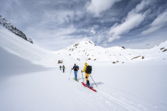 Ski tourers ascending from the Iffigtal to the Wildhornhütte, snow-covered mountain landscape,