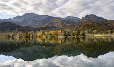 Autumnal mountain landscape with mountain peaks Herzogstand and Heimgarten, reflection in Lake