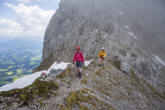 Two mountaineers with helmets in the mountains in fog, Wilder Kaiser, Kaiser Mountains, Tyrol,