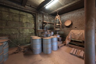 Metal barrels in the bronze powder filling room of a metal powder mill, founded in 1900, Igensdorf,