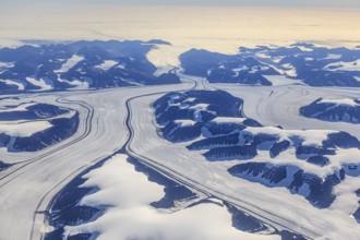 Aerial view of glaciers, glacier tongues and icy mountains on the coast, sunny, East Greenland,