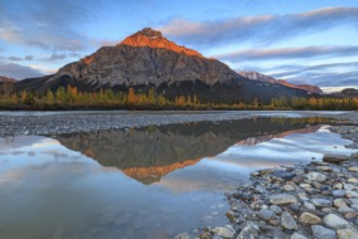 Clouds and evening light over mountains, mountain reflected in water, autumn, Brooks Range, Alaska,