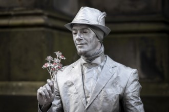 Street artists sprayed with silver paint, world's largest cultural festival The Fringe, High