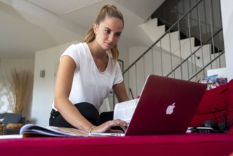 Young student learns at home, online, on her notebook