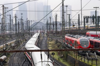 Railway tracks with regional and long-distance trains, ICE, after freezing rain, in front of