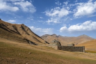 Historic caravanserai Tash Rabat from the 15th century, with yellow hills, Atbashy district in the