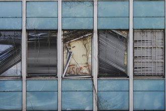 Broken windows and shutters of an abandoned office building loom in Berlin, 29/02/2024