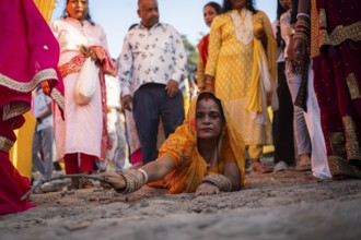 Hindu devotees perform rituals as they offer prayers to the Sun god in the bank of Brahmaputra
