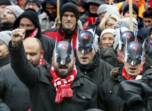 Wearing Batman masks, Volkswagen employees demonstrate in front of the Volkswagen Arena to mark the