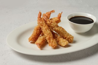 Fried shrimp, peeled in tempura, soy sauce, close-up