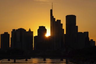The sun sets behind the Frankfurt banking skyline, Frankfurt am Main, Hesse, Germany, Europe