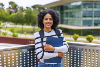 Portrait of a female smiling latin student with casual clothes and rucksack standing proud with