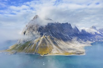 Gnalberget, mountain with steep sea cliffs in Hornsund fjord at Gnålodden in summer, Svalbard,