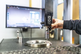 Close-up of the hand of a technician working with three-dimensional verification and measuring