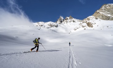 Ski tourers in a wintry mountain landscape, ascent to Porta d'Es-cha, Grisons Haute Route ski tour,