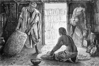 Interior of a hut in the Sahara oasis of Bardaï or Bardai, woman kneeling on the ground and