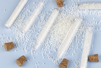 Corks and white beads are scattered on a blue surface