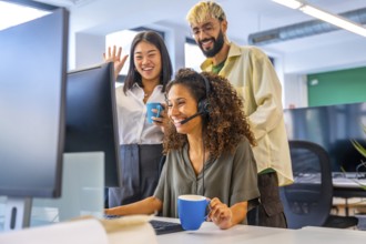 Coworkers drinking coffee and waving while making a video call suing headset