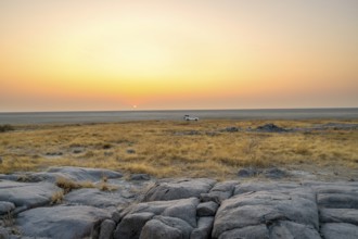 Off-road vehicle on a salt pan, at sunrise, Kubu Island (Lekubu), Sowa Pan, Makgadikgadi Salt Pans,
