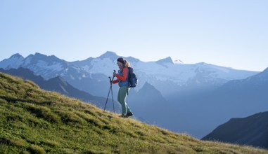 Hiker enjoying the mountain panorama in the morning, Venediger group, behind Dreiherrenkopf,