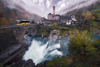 Village view of Lavertezzo on a rainy autumn day, post bus crossing a stone bridge, Verzasca